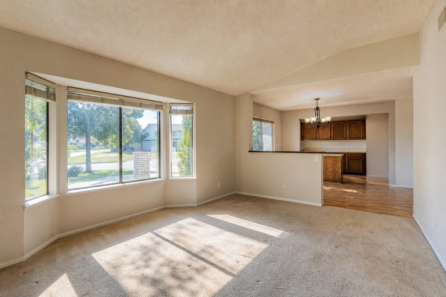 Bright interior living space of a mid-range Rancho Cucamonga home showing natural window light and typical 1990s-2000s finishes.