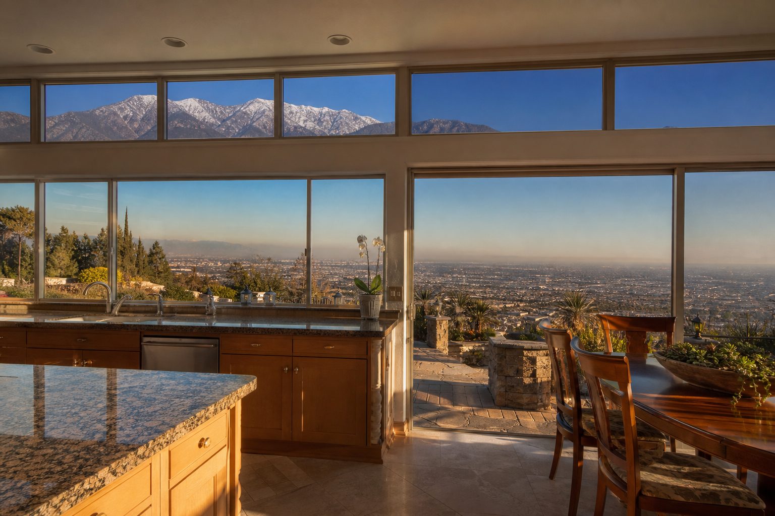 Luxury kitchen with dual mountain and city-light views from elevated Etiwanda home, showing north-south vista and natural morning light.