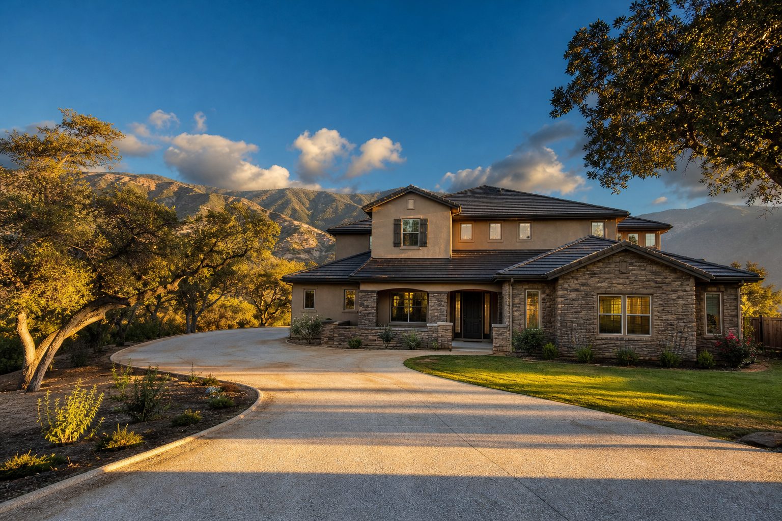 Contemporary two-story Alta Loma foothill home with Class A roof, mature defensible space, and San Gabriel Mountains visible in background at golden