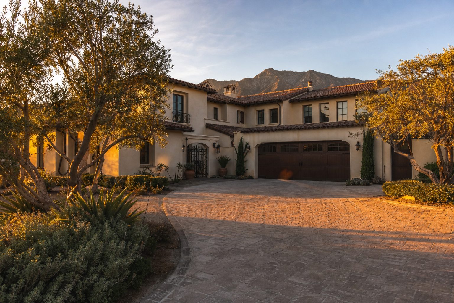Two-story stucco home with tile roof and mature shade trees in Rancho Cucamonga foothill community.
