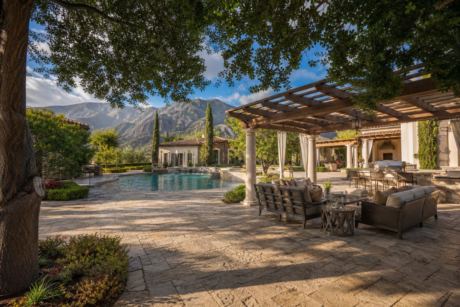 Luxury estate resort-style patio with pool, pergola, mature landscaping, and San Gabriel Mountain views in Rancho Cucamonga.